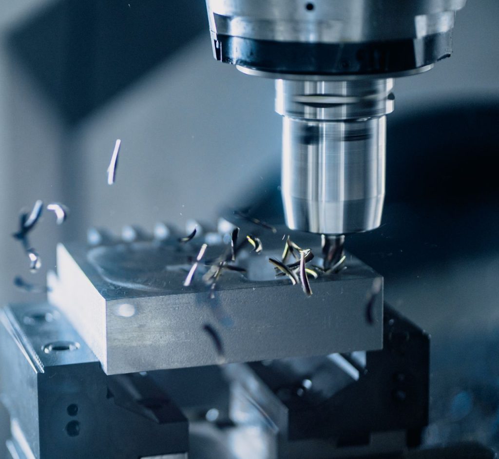 gallery-01 Close-up of a CNC milling machine working on metal for precise manufacturing.