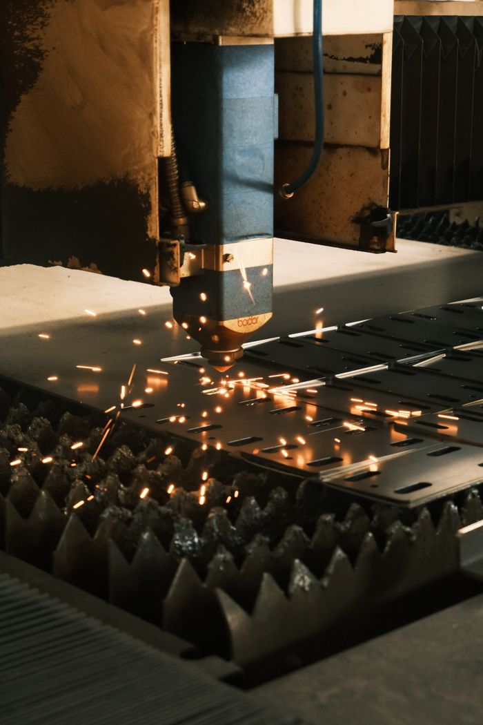 Mastering the First Impression: Your intriguing post title goes here Close-up of a laser cutter in action, producing sparks in a modern manufacturing facility.